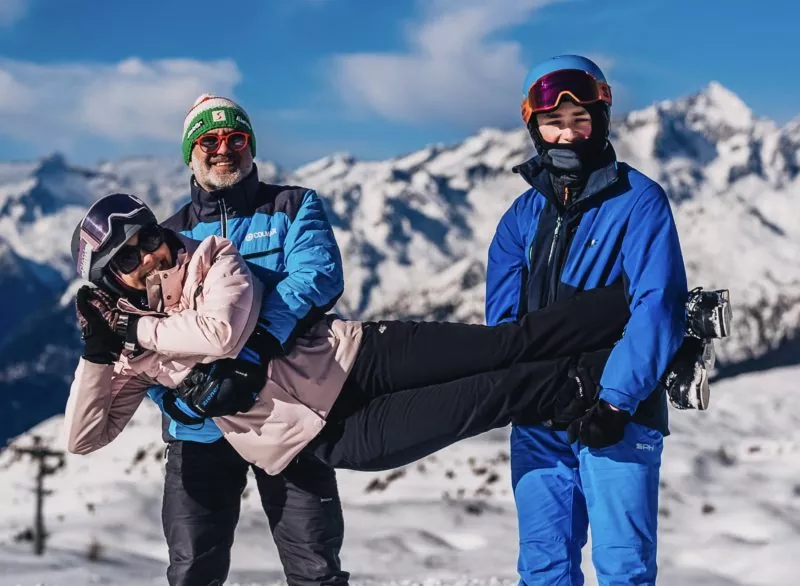 Rodzina na nartach w górach. Radosna atmosfera, zimowy krajobraz, sporty zimowe.