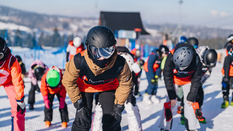 Dzieci na nartach, lekcja narciarstwa dla początkujących. Zimowy sport, nauka jazdy na nartach.